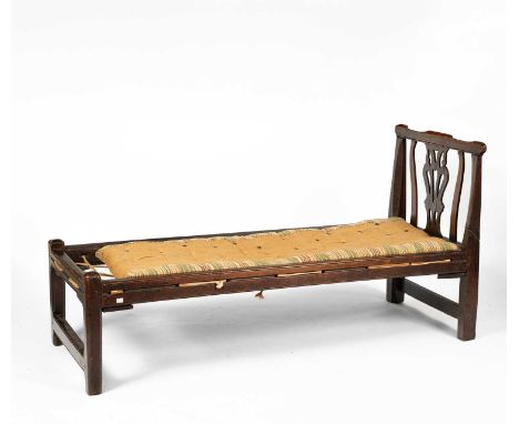 An 18th Century provincial splat chair-back daybed, possibly Welsh, the serpentine toprail above a pierced carved splat back,