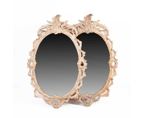 Two Rococo style resin moulded mirrors each with an oval plate within a Rococo cast surround, each: 114cm x 74cm (2)