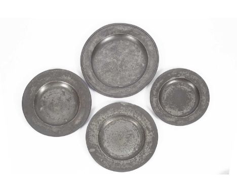 A triple-reeded pewter charger, circa 1680, 51cm diameter, a pewter reeded rim charger, 46cm diameter, another pewter charger