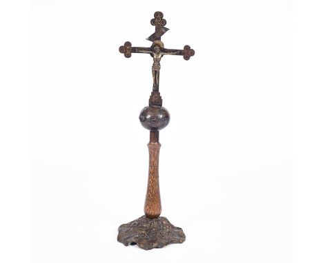 A 20th Century iron Crucifix upon a globe and wooden stem with rocky base, monogrammed and dated 1995, 70cm high
