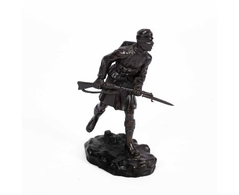 A 20th Century bronze figure of a WWI soldier carrying a rifle with bayonet, possibly Italian, on a rusticated base, signed C