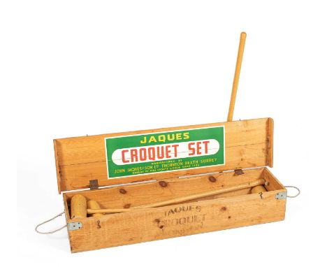 A Jaques wooden cased croquet set with four mallets, four balls, six hoops and a centre peg, 110cm wide