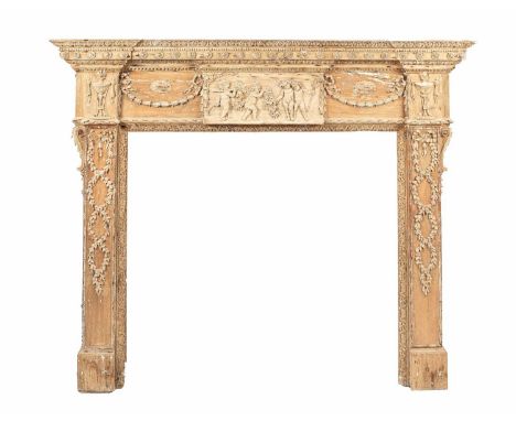 An Adam style pine fire surround, the frieze with central carved tablet of bacchanalian putti, applied swag, urn and ribbon t