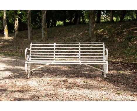 A white painted metal garden bench with scroll arms and scroll supports, 182cm wide
