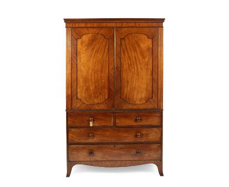 A Victorian mahogany linen press the moulded cornice above two panelled doors enclosing five open drawers, above two short an