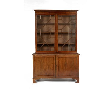 A George III mahogany bookcase the adjustable selves enclosed by two astragal glazed doors, the cupboard base on bracket feet