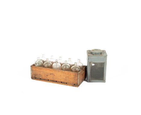 An antique crate fitted with ten glass bottles, 64.5cm wide x 30cm high and a lantern, 40cm high