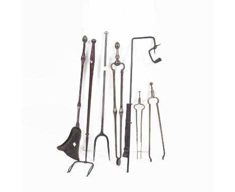 A long handled iron rushlight holder, a fire shovel and tongs, a log fork, a toasting iron and two pairs of tongs, various si