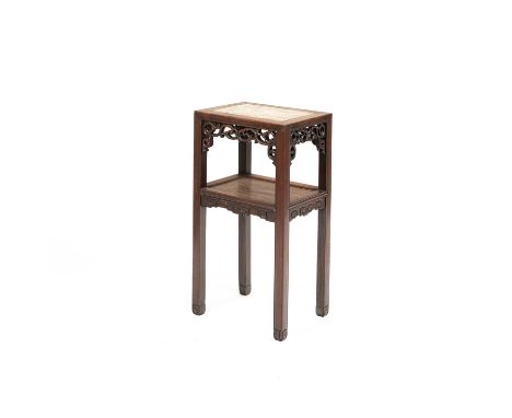 A Chinese hardwood stand the rectangular top with marble insert, above a pierced carved frieze, the undertier with scroll car