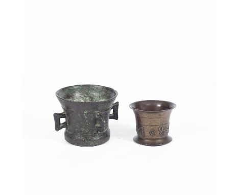 A bronze mortar with four lug handles, 29cm x 19cm and another with inscription, 15cm x 11.5cm (2)  The larger with one old r
