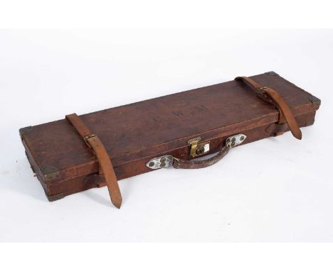 A leather gun case by W Evans Ltd with brass corners and a fitted interior, paper retailers label to side, embossed initals '