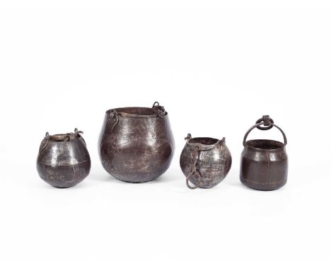 Four hanging iron cooking pots with loop handles, the largest 29cm x 30cm