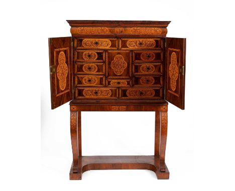 A William &amp; Mary walnut seaweed marquetry cabinet having a drawer to the frieze, fitted four drawers enclosed by a panel 