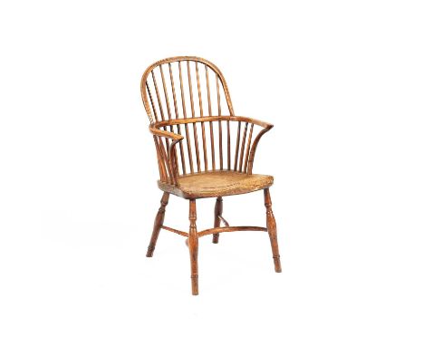 A 19th Century Windsor type armchair, with yew wood arms and dished elm seat, previously adapted as a commode, on turned legs