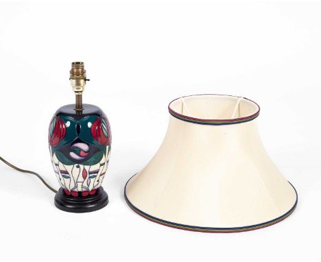A Moorcroft lamp, ‘Tribute to Charles Rennie Mackintosh’, tube lined, mounted on a wooden circular base, 30cm high (not inclu