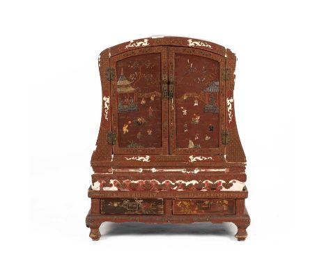 A Chinese red painted cabinet on stand the arched top above two cabinet doors with bone and hardstone relief decoration, the 