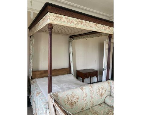 A late 18th Century Chippendale period mahogany four poster bed, the canopy with moulded cornice and blind fret frieze, with 