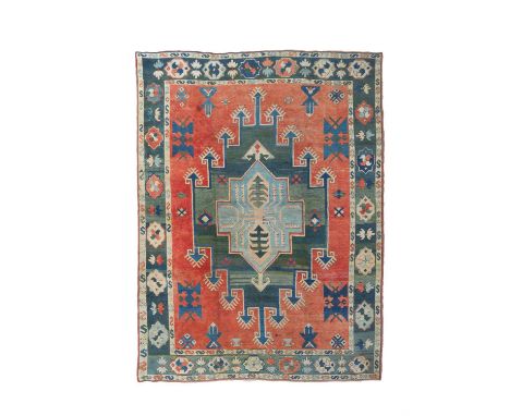 A Milas carpet, Anatolia, 20th Century, the pale red field centred by a large abrashed green stepped medallion centred by a f