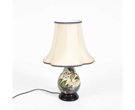 A Moorcroft lamp, Bramble pattern, tube lined with strawberries, flowers and bees, shape no. 717, mounted on a circular woode