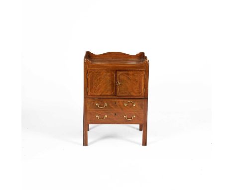 A George III mahogany bedside commode, the galleried top with pierced handles above doors, a commode drawer below, 56cm wide,