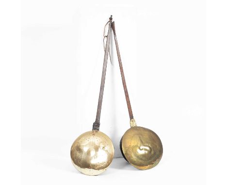 Two 17th Century iron and brass bed warming pans, one with pricked decoration to the cover, the other faintly inscribed 'God 