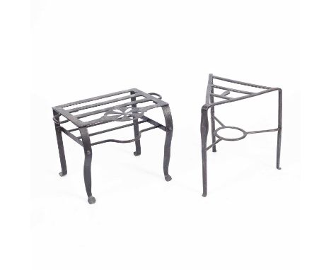 A triangular iron trivet on tripod legs, 40cm wide and a rectangular trivet on four legs, 44cm wide