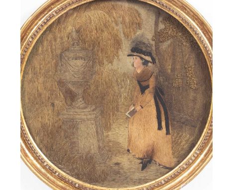A needlework picture, 19th Century, circular depicting a lady stood by an urn marked 'Werter', the lady with painted face, 31