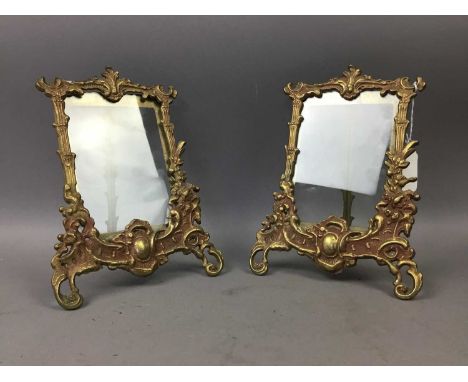 PAIR OF BRASS PHOTOGRAPH FRAMES,each ornately cast with leaf and scroll designs around the glass fronted aperture, with easel