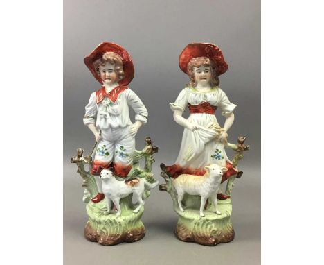 PAIR OF LATE 19TH CENTURY GERMAN CERAMIC FIGURES,of a girl and boy with lamb and dog, 24cm high (2)