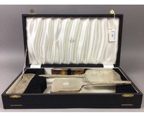 SILVER VANITY SET,comprising a hand mirror, comb and two brushes, Birmingham marks, in a fitted case