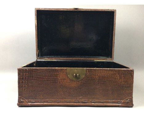 CHINESE LACQUERED TRUNK,in simulated lizard skin with brass handles and lock clasp, 47cm wide, along with a carved wood panel