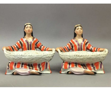PAIR OF RUSSIAN CERAMIC FIGURAL SALTS,in the form of seated female figures holding a basket, 10cm high, along with a pair of 