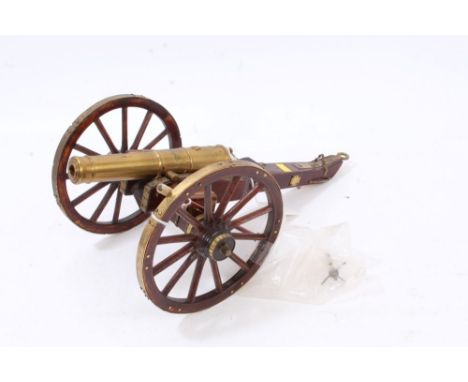 Decorative scale model of a Napoleonic-style cannon with wooden carriage and brass mounts, 36.5cm overall