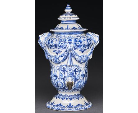 A Dutch Delftware fountain and cover, 18th c, moulded with swags from lion masks and painted in blue with dolphins and other 