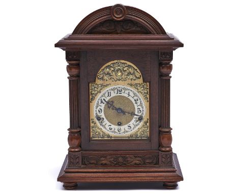 A German walnut bracket clock, c1910,&nbsp; the breakarched brass dial with matted centre and silvered chapter ring, in card 