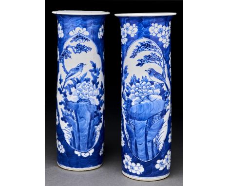A pair of Chinese blue and white cylindrical vases, Qing dynasty, late 19th c, painted with two reserves of a bird in a tree 