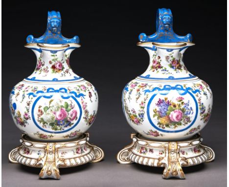 A pair of French porcelain ewers in the form of a trilobed oinochoe, mid 19th c, painted with flowers and festoons framed by 