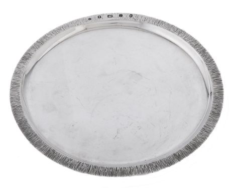 An Elizabeth II modernist silver salver, 25cm diam, maker's mark S N within an apple shaped punch, London 1977, 13ozs 5dwts C