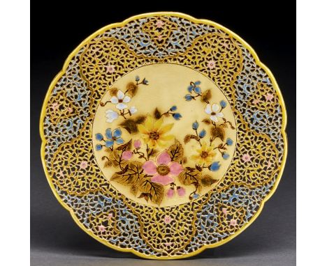 A Zsolnay reticulated charger, late 19th c, decorated with pink, yellow and other flowers in openwork polychrome border and l