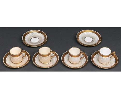 A set of four Minton white and gilt bone china coffee cups and eight saucers, 1887, saucer 10.5cm diam, impressed mark, patte