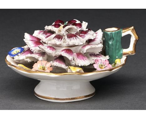 A Staffordshire carnation shaped and floral encrusted handled inkwell and cover, c1820, the handle incorporating a taper hold