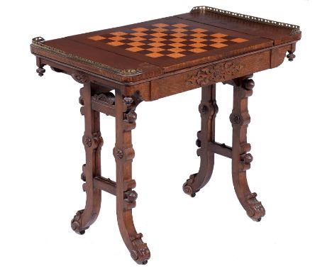 An early Victorian Elizabethan oak games table,&nbsp;the oblong top with brass end-galleries, the reversible centre section r