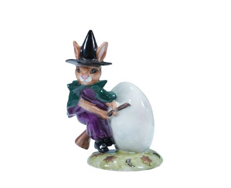This prototype colorway features a rabbit dressed as a witch in a purple dress and green cloak, with a black pointed hat. The