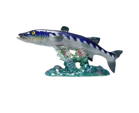 Depicting a barracuda in a streamlined, curved pose with open mouth and extended fins. The surface is finished in a combinati