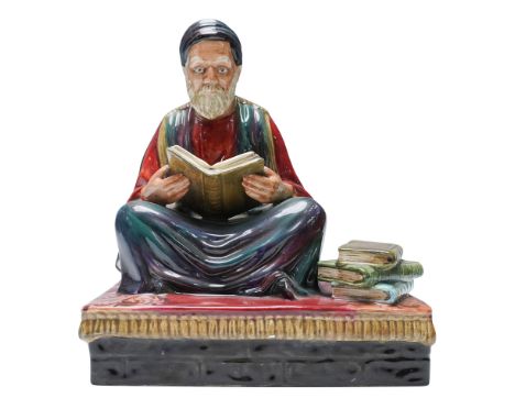 This detailed ceramic sculpture portrays a seated scholar engaged in study, dressed in traditional robes and turban, with a s