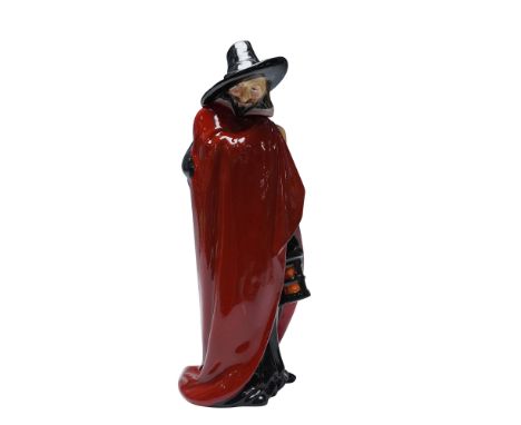 The figure is depicted standing in a black robe with a red cloak draped over his shoulders and a white collar around the neck