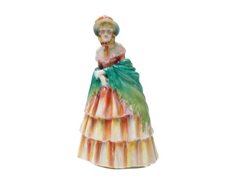 This hand-painted figure features a woman in Victorian-era attire, wearing a tiered dress in shades of orange, pink, and crea