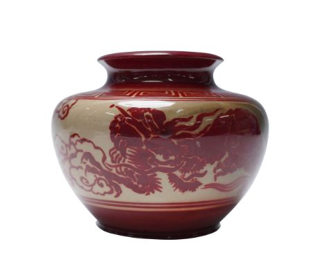 Decorated in traditional flambe glaze, this Bernard Moore pottery vase features a continuous Japanese-style dragon motif enci