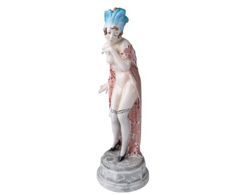 A captivating Art Deco ceramic figurine by Wilhelm Thomasch for Goldscheider, featuring a stylishly posed female figure drape