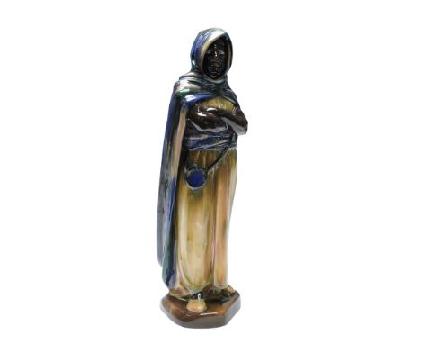 Royal Doulton porcelain figurine titled 'The Moor' also known by 'An Arab'. The figure is modeled standing with arms folded a